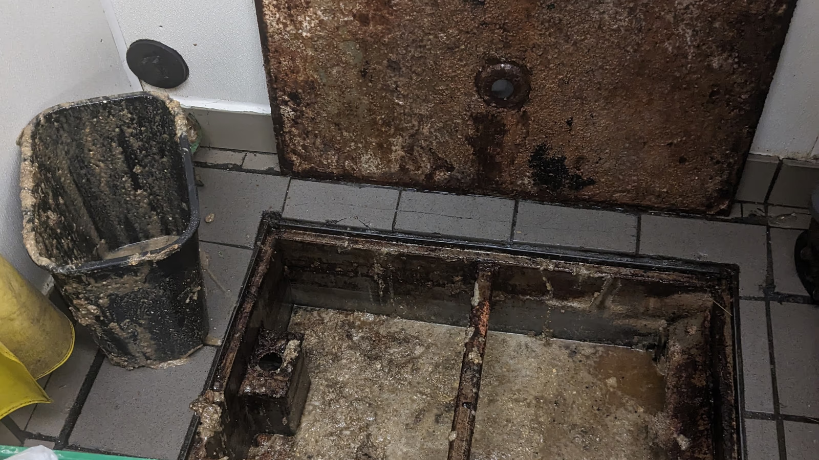 Commercial grease trap being cleaned at a Miami-Dade restaurant